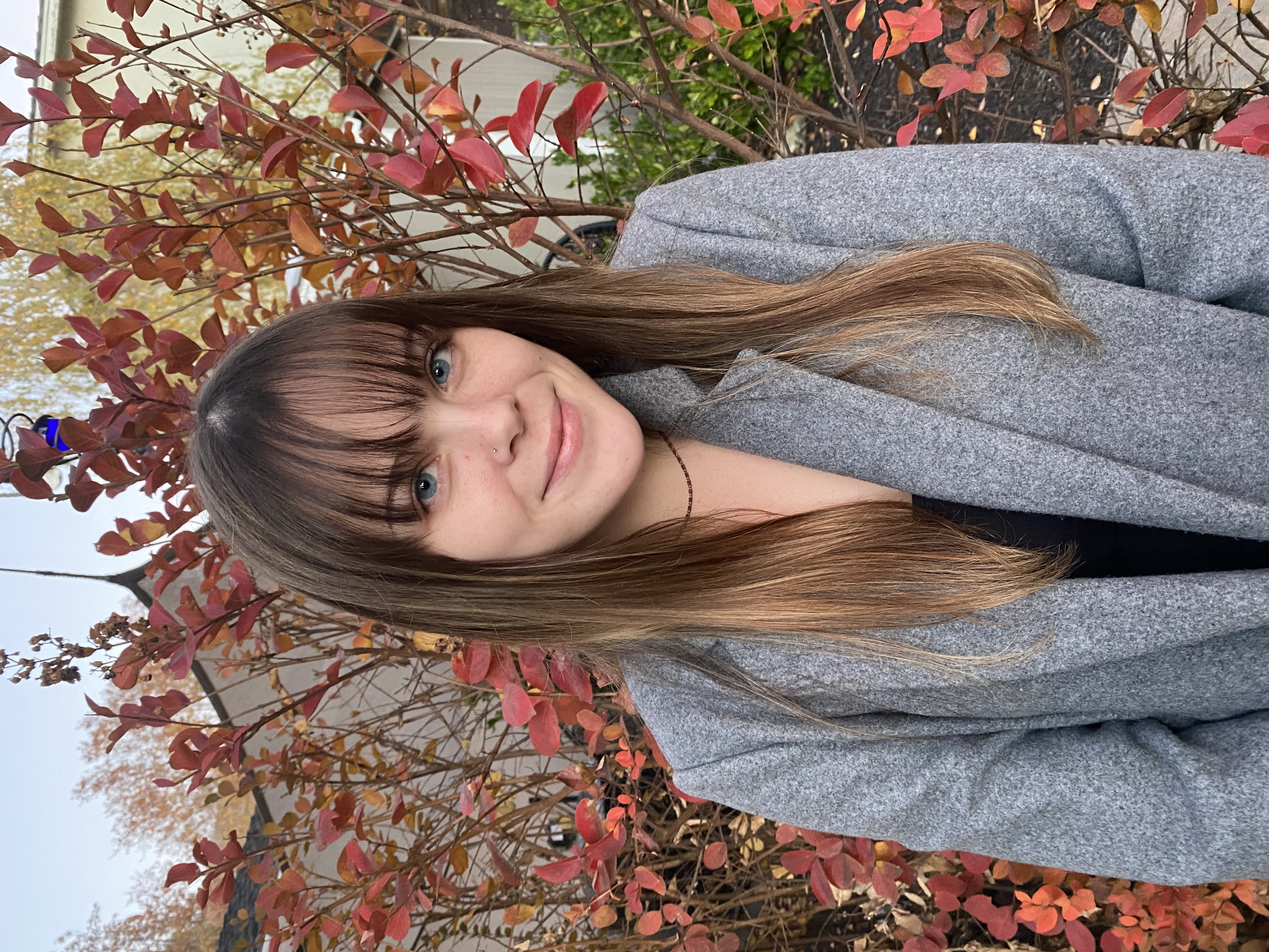 image of Maya Morris standing in front of a tree