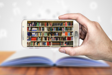 cell phone with an image of a library shelf and books