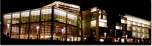 Photo of the exterior of the UC Merced Library lit up at night. 