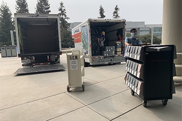Library staff unloading collections on campus