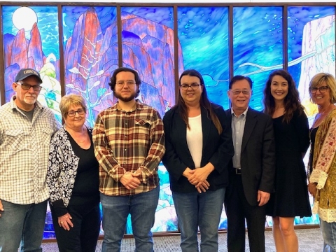 Award recipients with Arlene Kranich (donor), Breland family members, and University Librarian in front of stained-glass murals