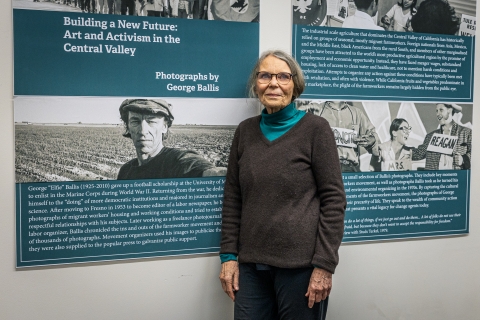 Maia Ballis stands in front of exhibit