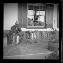 Man posing with Smith Indian backpack fire pumps