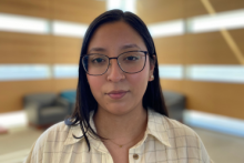 photo of MJ Juarez- dark black hair, white button up blouse and framed glasses